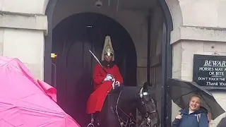 Heavy Rain and tourist at King's horse guard at House of cavalry London