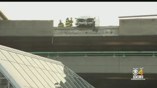 Car sends concrete barrier crashing down onto Alewife MBTA station