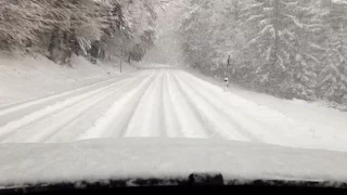 BMW X6 xDrive40d Driving up a Mountain Road in Deep Snow