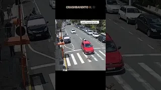 Motorcycle Crashes into Car in Busy Street