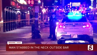 Man stabbed in neck outside Broadway bar