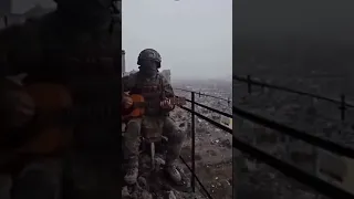Russian soldier playing his guitar in  Bakhmut. Privet sestrenka