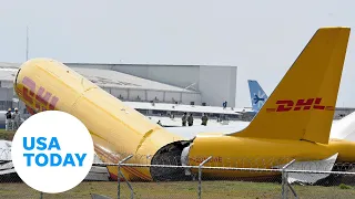 DHL cargo plane skids off runway, breaks in half during rough landing | USA TODAY