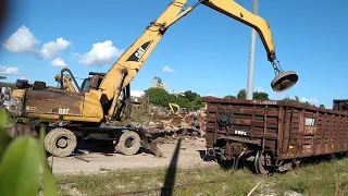 Loading rail cars with scrap & loaded FEC intermodal freight train headed south