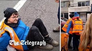 Just Stop Oil activist falls to the ground as car drives through protest