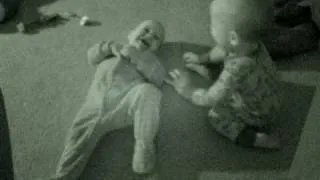 Twin baby boys laughing and tickling eachother