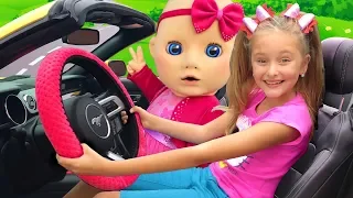 Sasha plays with a big doll and sings funny songs