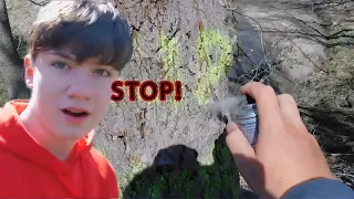 Spraying clear spray-paint at a public park