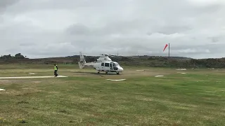 AS365 Dauphin helicopter G-PDGO taking off from Tresco Island UK flying for Penzance Helicopters