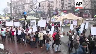 Protesters marched through the opposition protest camp in Independence Square carrying blank signs r