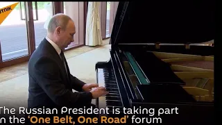 Putin plays roving tank on piano