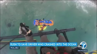 Video shows dramatic rescue of driver who drove off highway, crashed into ocean