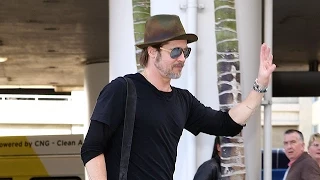 Brad Pitt Plays It Up For The Paps At LAX