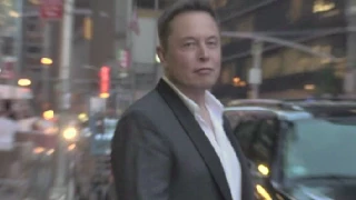Elon Musk greeting fans .