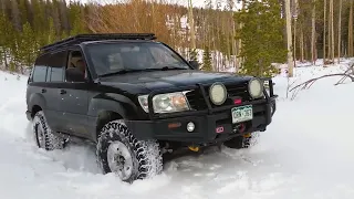 100 Series Land Cruiser making fresh tracks through deep snow