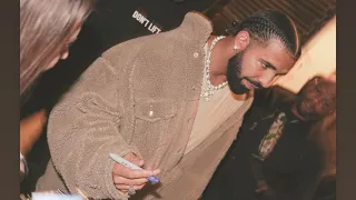 DRAKE SIGNING AUTOGRAPHS FOR FANS AFTER A LONG DAY.