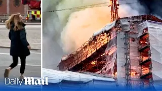 Emotional woman attempts to enter Copenhagen's burning stock exchange