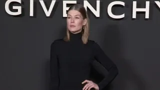 Rosamund Pike poses for the photographers before the Givenchy Fashion Show in Paris