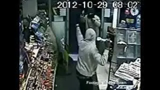 Brave shop worker fights off robber armed with a needle by threatening him.