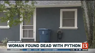 Woman found dead with python