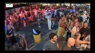 at Fantasy Fest, woman tumbles into the street, doesn't spill drink.