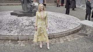 Elle Fanning poses for the photographers before the Miu Miu Fashion Show in Paris