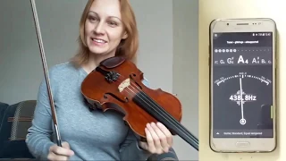 Tuning a violin using a tuner.