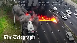 Moment cars drive through flames after bus fire in Argentina