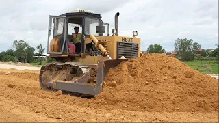 HBXG Bulldozer, Dump truck unloading dirt on new road
