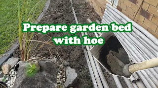 Prepare garden bed with hoe