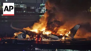 Plane bursts into flames on airport runway in Tokyo, Japan