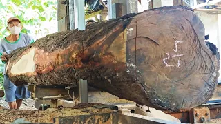 Processing old acacia wood into thick boards for doors and tables