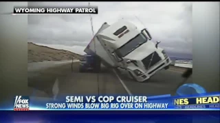 High Winds Tip Semi Truck Directly Onto A Cop Cruiser On A Wyoming Highway