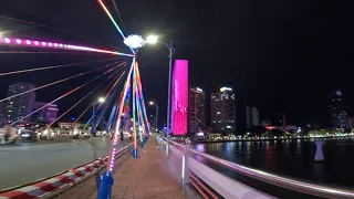 A night time walk across the Cầu Sông Hàn (Han River Bridge) in Da Nang.