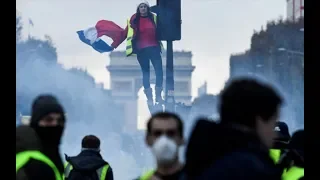 Police fire tear gas at 'yellow vest' fuel protesters in Paris