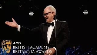 John Lithgow presents to Claire Foy at the Britannia Awards