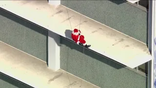 Santa arrives by helicopter to deliver toys in LA