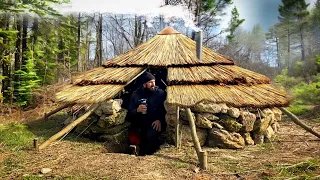 Building of a round bushcraft dugout for survival in the wild