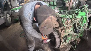 Removing crank shaft from 6068 John Deere engine.