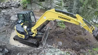 Hammering rock with an excavator