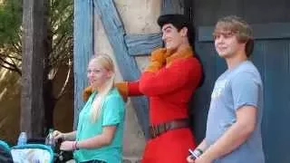 Belle grabs a book from GASTON at Disney World Magic Kingdom