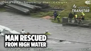 Crew pulls a man stuck in rushing high water to safety