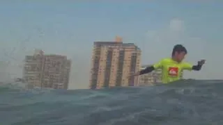 Little dude in yellow surfing North Beach.