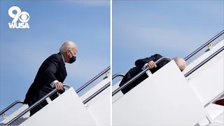 Biden trips going up the stairs of Air Force One