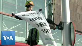 8-Year-Old Climate Activist Climbs Street Light in Protest