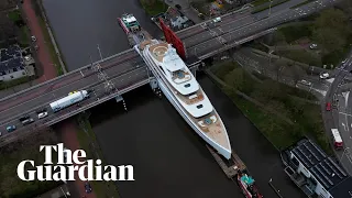 Superyacht towed through narrow canal in Netherlands