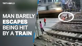 Man barely escapes being hit by a fast train in India