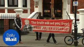 Protestors unfurl pro-Assange banner outside Ecuadorian embassy