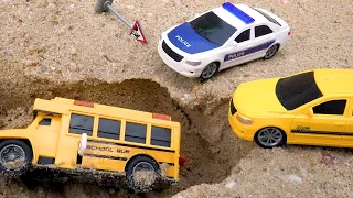 Police cars help the bus escape the sand pit