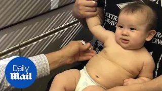 Doctor distracts baby from her shots with goofy tune